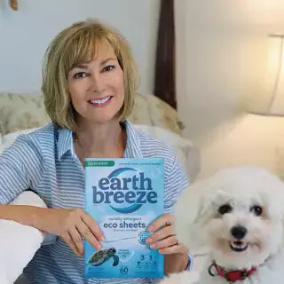 Customer with Earth Breeze detergent and dog